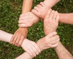 Canva - Group of People Holding Arms